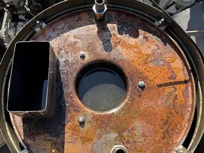 Open boiler on Nilfisk Contractor diesel pressure washer showing water inside jacket after coil failure.